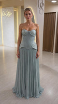 Front view of model wearing sage green strapless corset evening dress