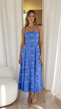Front view of woman wearing blue floral embroidered midi dress
