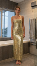 Front view of model wearing gold sequin maxi dress