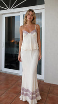 Model wearing ivory satin camisole and maxi skirt set