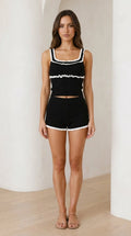 Front view of model wearing black contrast ruffle knit lounge set