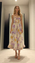 Full front view of model wearing white floral corset midi dress