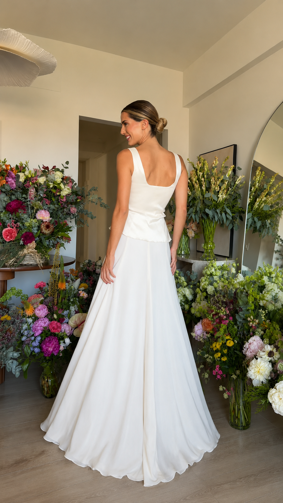 Back view of white square neck peplum maxi dress with flowing full-length skirt
