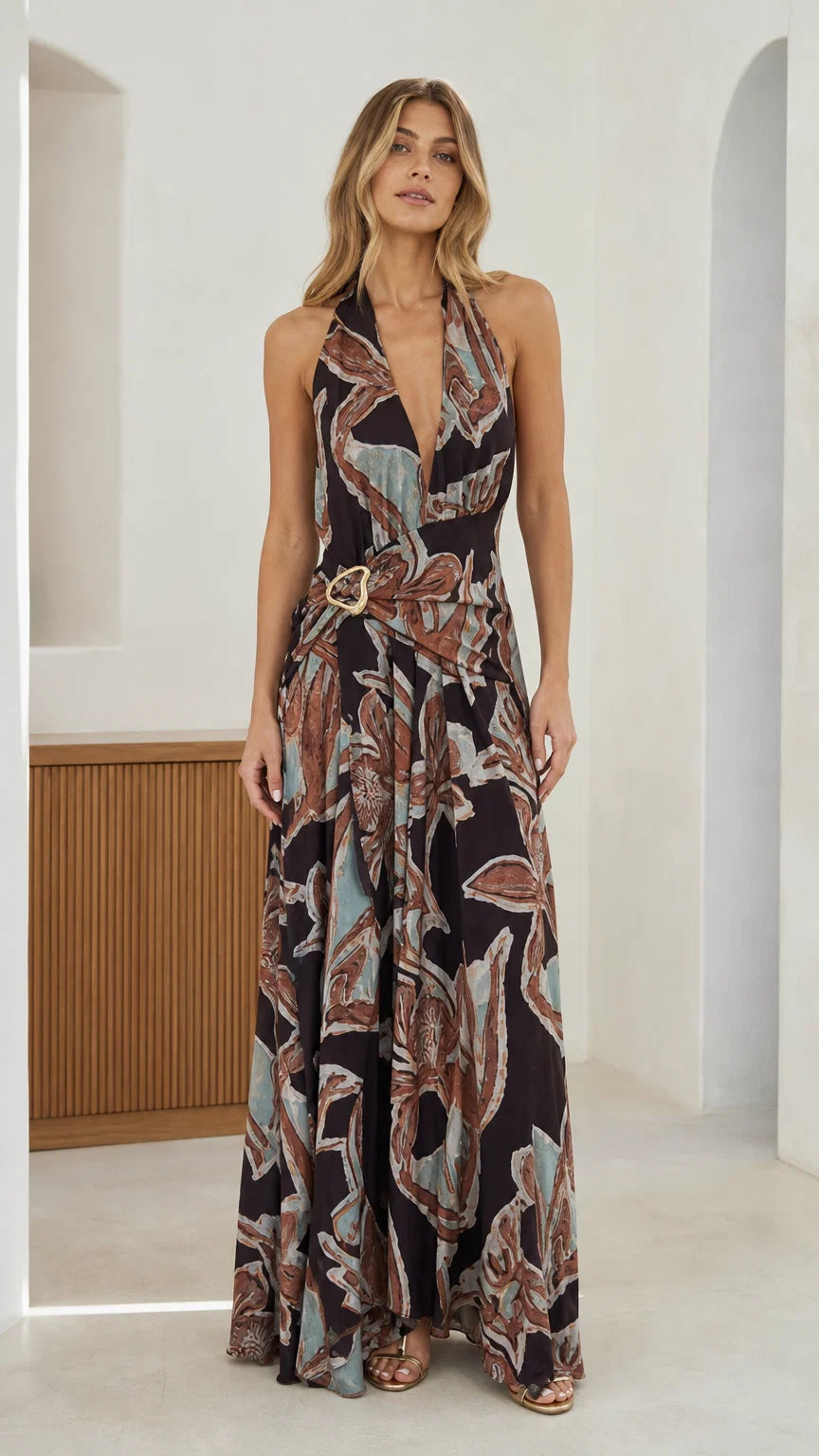 Front view of black abstract print halter maxi dress with O-ring belt