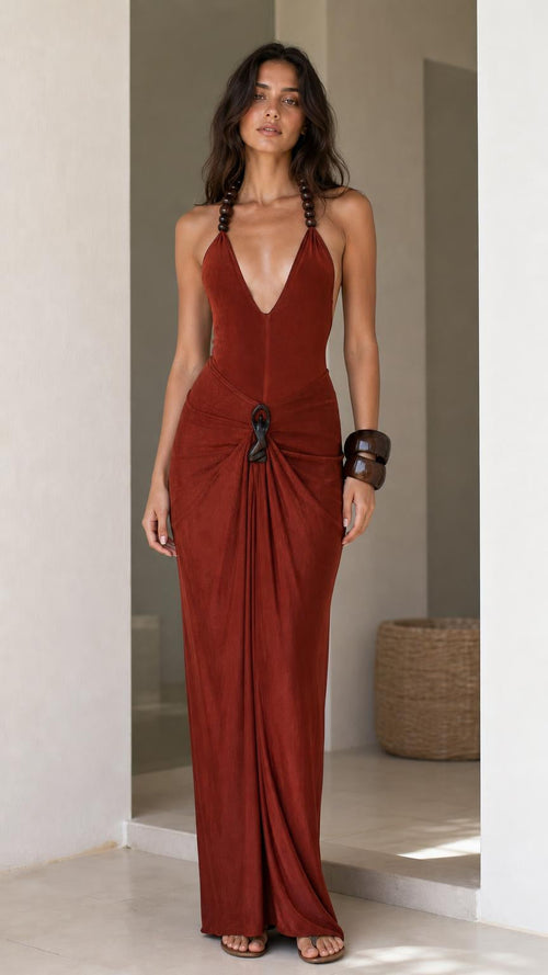 Model wearing rust halter maxi dress from the front