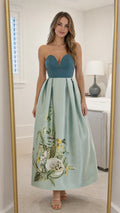 Front view of sage green strapless floral embroidered maxi dress in mirror