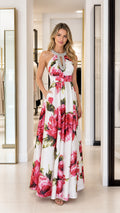 Front view of woman wearing white floral long maxi dress with rhinestone halter neck