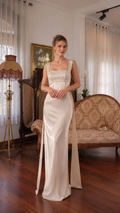 Front view of ivory satin-look maxi evening dress with square neckline and embellished bodice