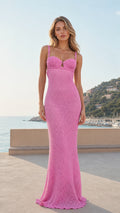 Front view of woman wearing pink crochet maxi dress