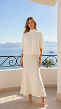 Front view of cream mock neck batwing top and maxi skirt set