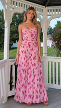 Front view of model wearing pink strapless pleated floral maxi dress