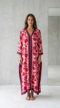 Front view of model wearing pink floral long kaftan maxi dress