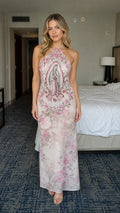 Front view of model wearing pink floral halter maxi dress