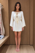 Front view of model wearing white bohemian lace trim mini dress