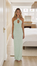 Model wearing mint green halter maxi dress from the front
