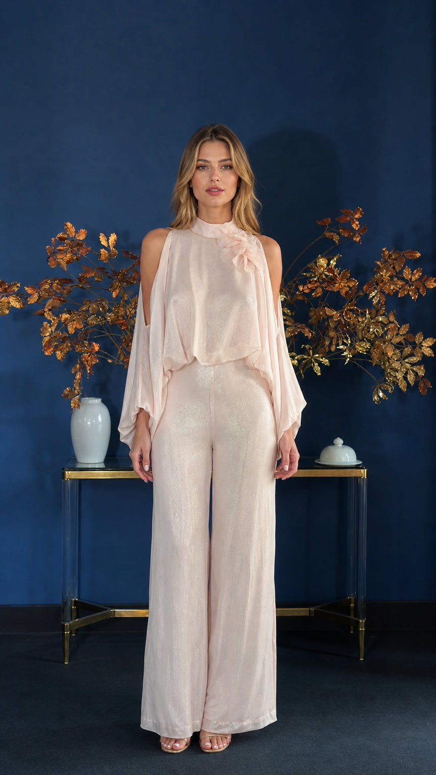 Front view of model wearing champagne cold-shoulder overlay jumpsuit