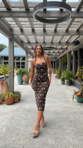 Front view of chocolate brown polka dot bodycon midi dress with square neckline