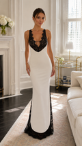 Front view of ivory maxi dress with black lace plunge neckline and mermaid silhouette