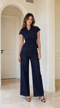 Model wearing navy blue zip-up denim top and wide-leg pants set, front view