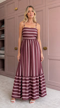 Woman wearing burgundy striped tiered maxi dress front view