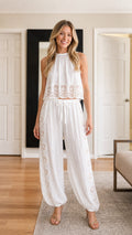 Model wearing white boho lace crop top and jogger pants set front view