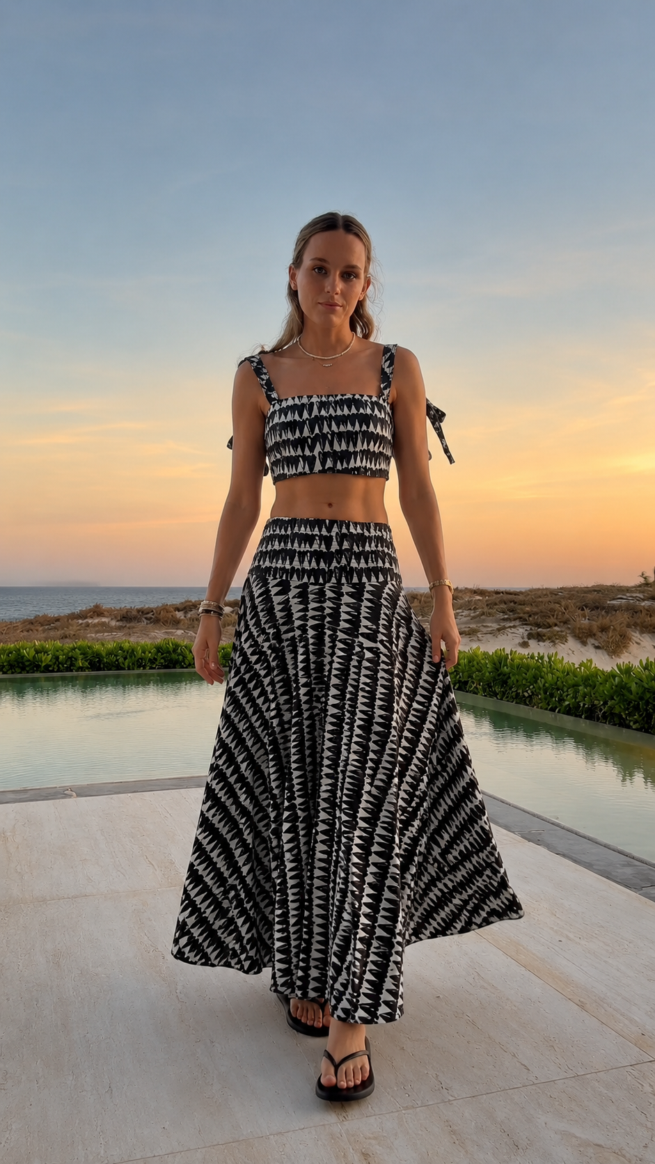 Front view of black printed smocked crop top and maxi skirt set