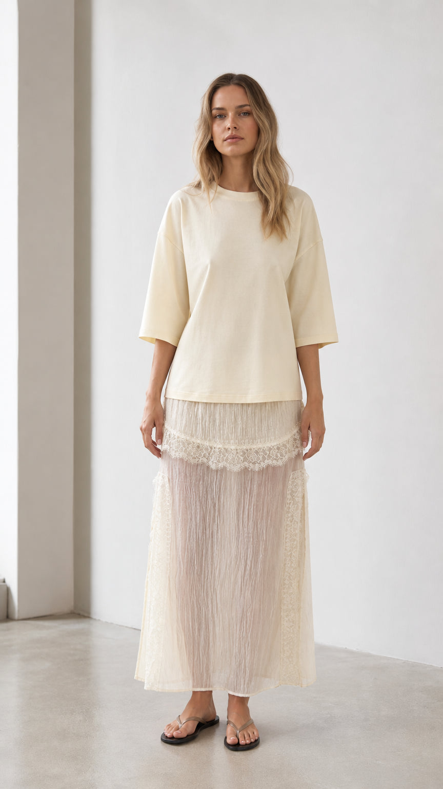 Front view of woman wearing cream relaxed tee and matching mesh maxi skirt