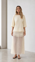 Front view of woman wearing cream relaxed tee and matching mesh maxi skirt