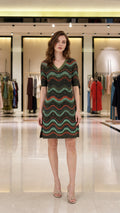 Front view of model wearing multi-color metallic wave knit dress