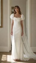 Front view of white lace maxi dress with cape