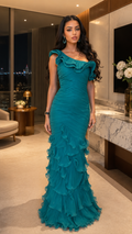 Front view of teal one-shoulder ruched mermaid maxi gown with layered ruffle hem