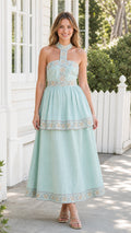 Front view of model wearing mint embroidered halter midi dress