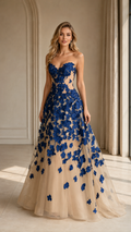 Front view of royal blue floral appliqué strapless A-line evening gown with nude illusion base