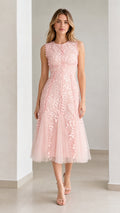 Front view of model wearing pink embroidered leaf applique midi dress