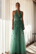 Front view of green embroidered halter evening dress