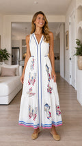 Front view of woman wearing white butterfly print maxi dress