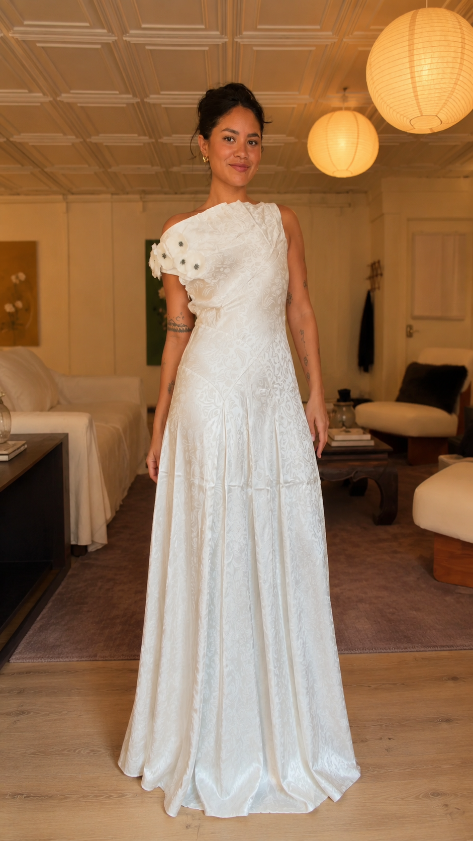 Front view of white one-shoulder floral appliqué maxi gown