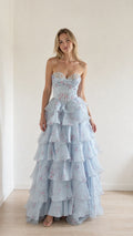 Front view of model wearing light blue floral ruffle strapless corset evening gown