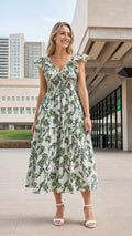 Front view of woman wearing white floral ruffle smocked midi dress