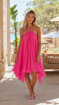 Full front view of a woman wearing the pink halter sun dress outdoors