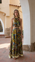 Full front view of model wearing brown printed halter neck cutout maxi dress