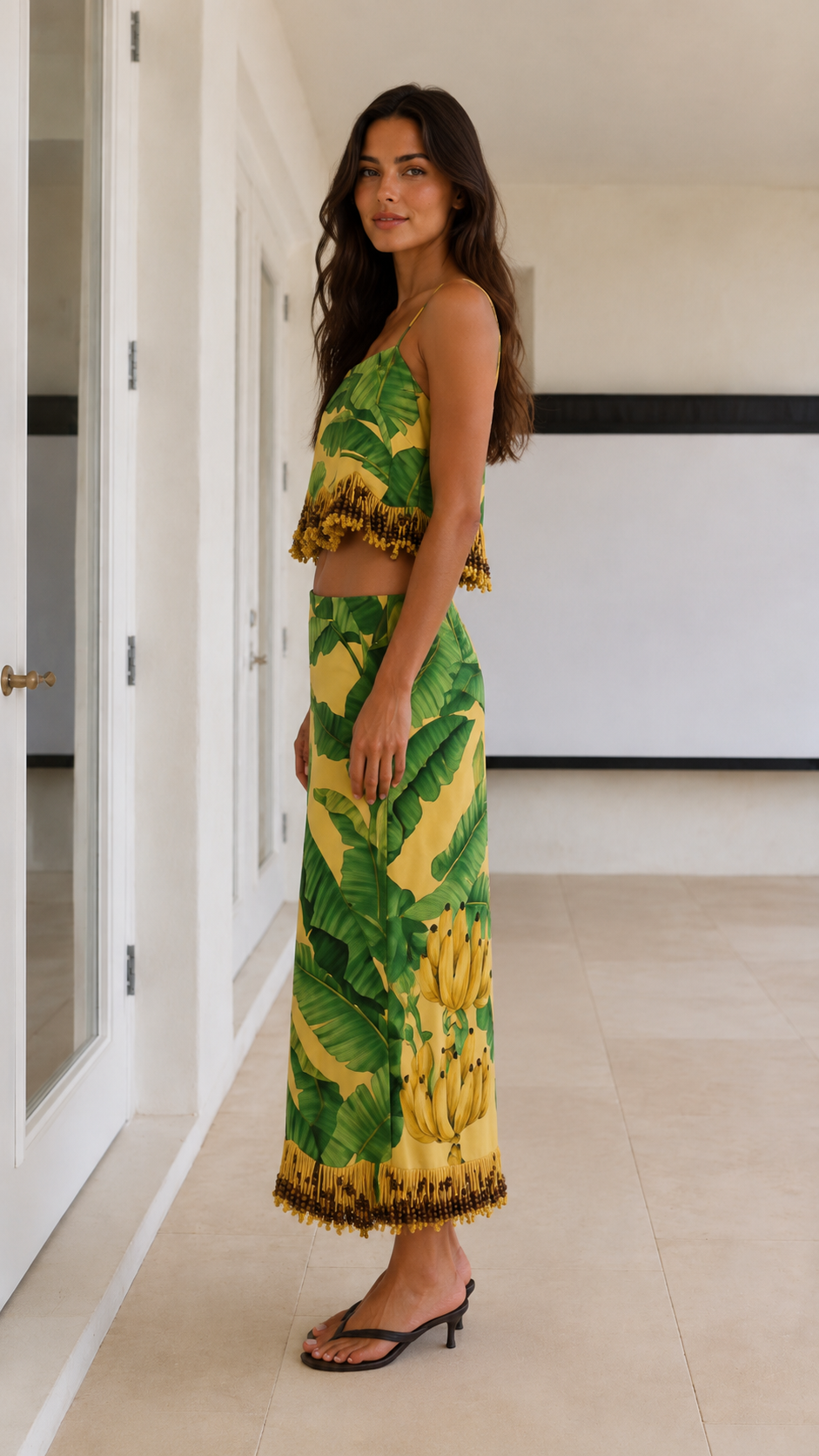 Side view of yellow tropical print matching cami top and maxi skirt set