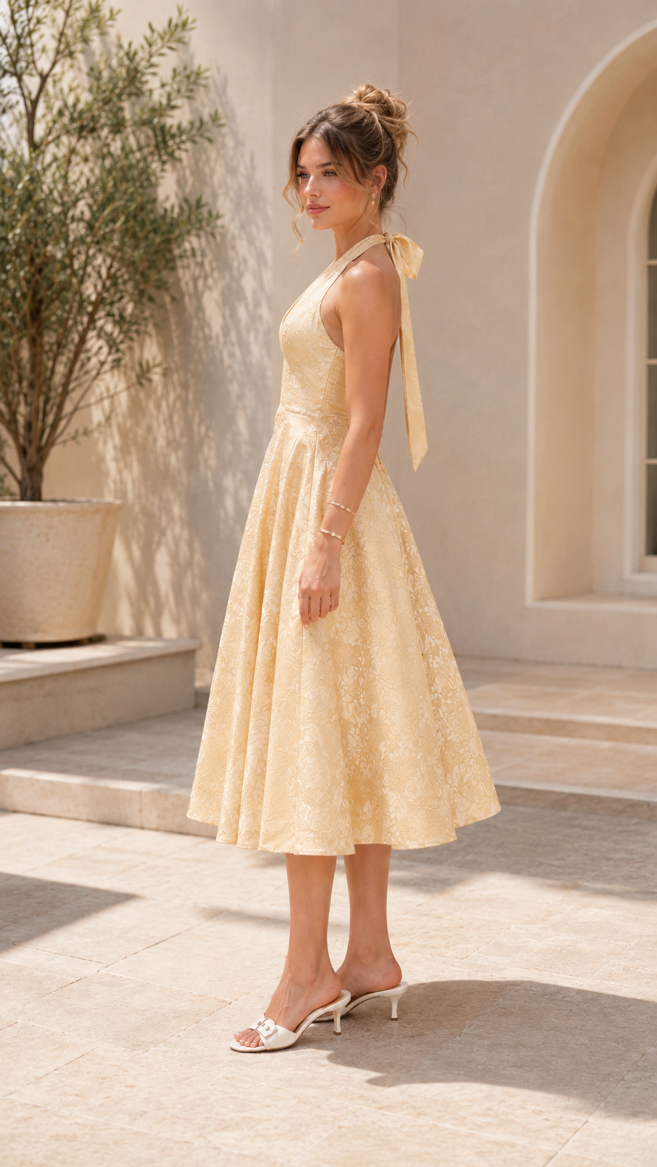 Side view of champagne halter midi dress with tie-back neckline