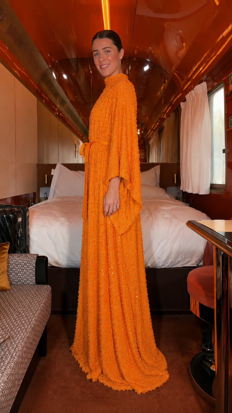 Side view of orange flowing high-neck maxi caftan dress with waist tie