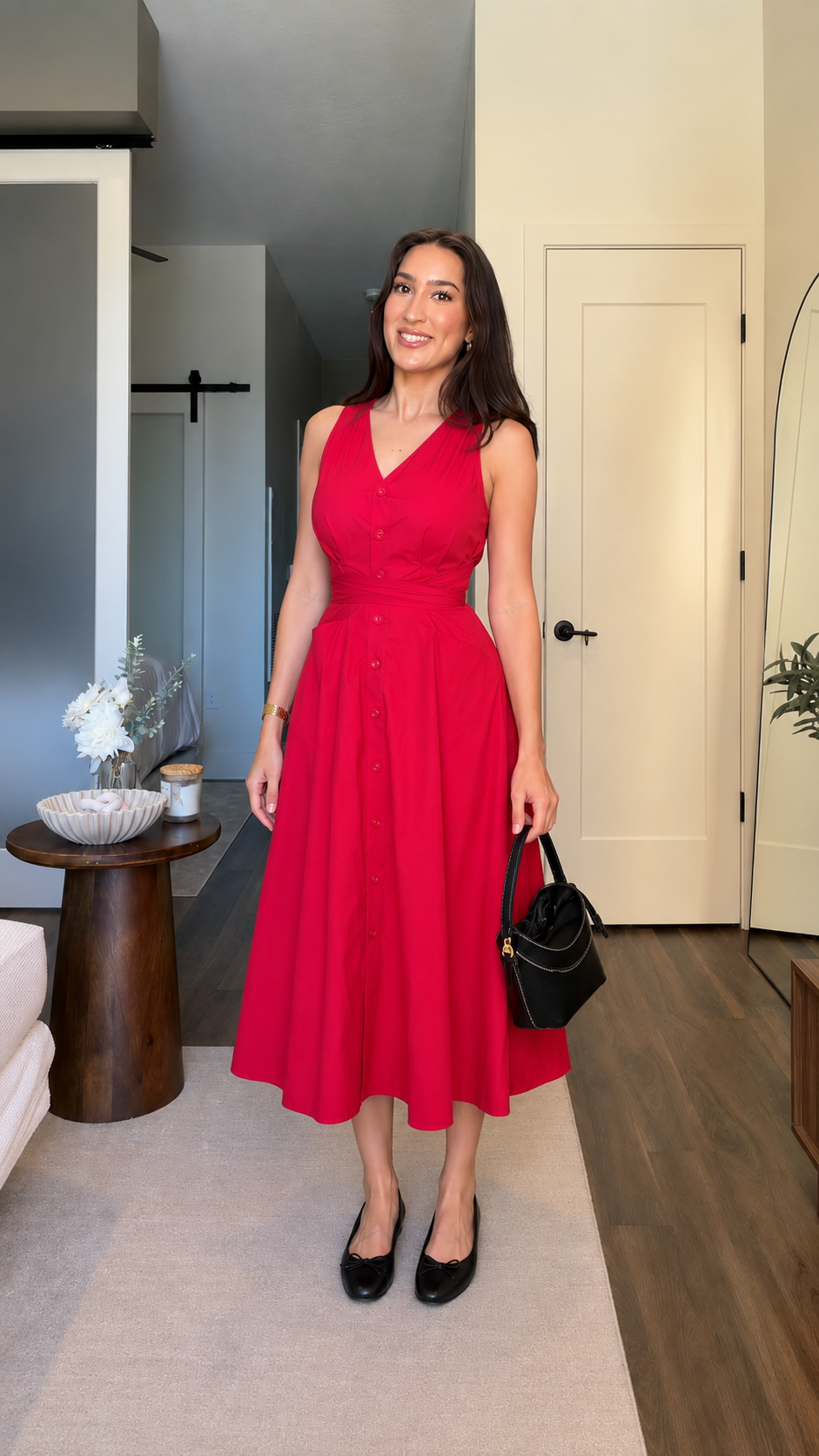 Red sleeveless fit-and-flare midi dress styled with black flats and handbag
