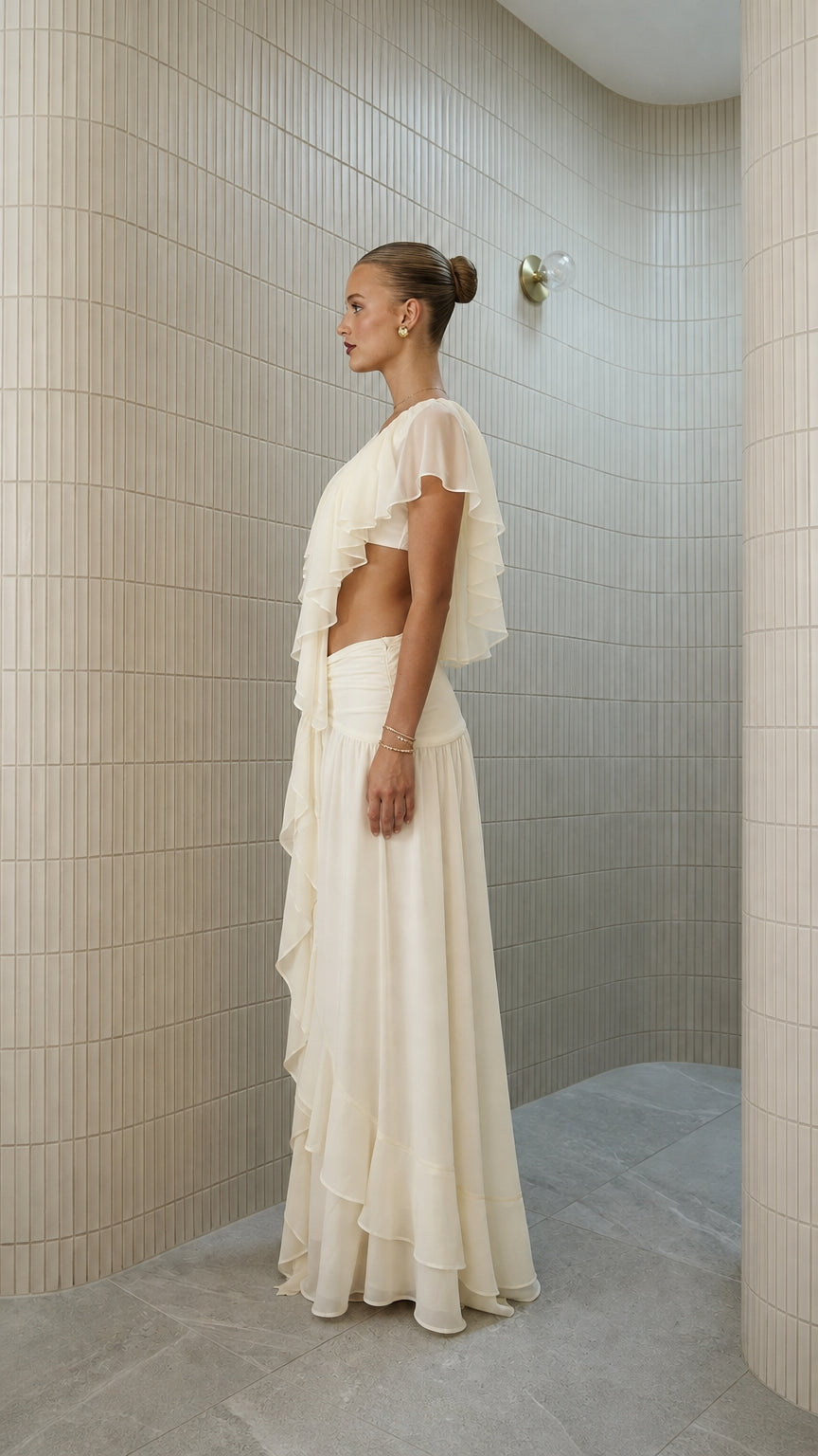 Side profile view of ivory ruffled crop top and maxi skirt
