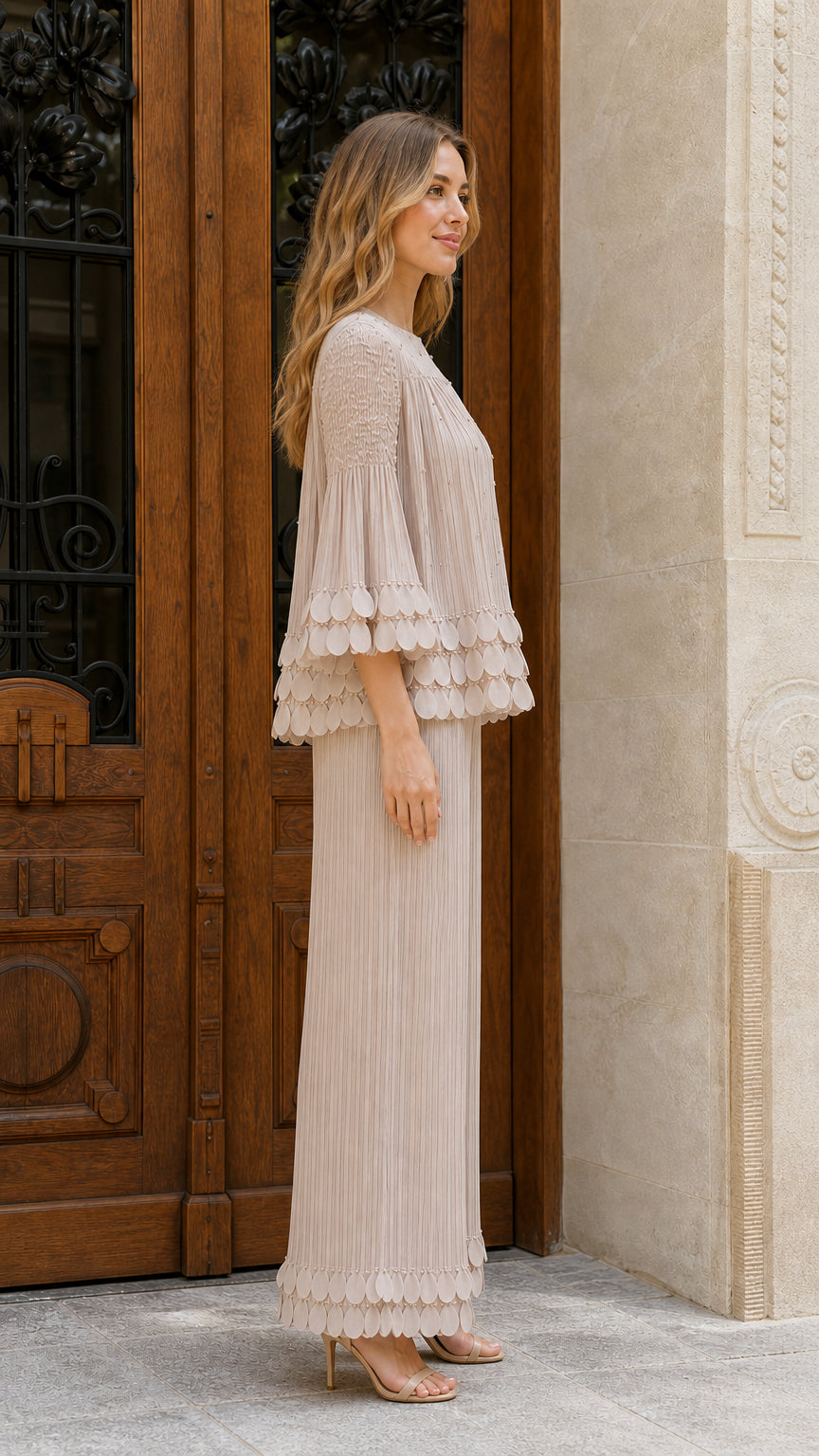 Model wearing beige pleated two-piece set side view