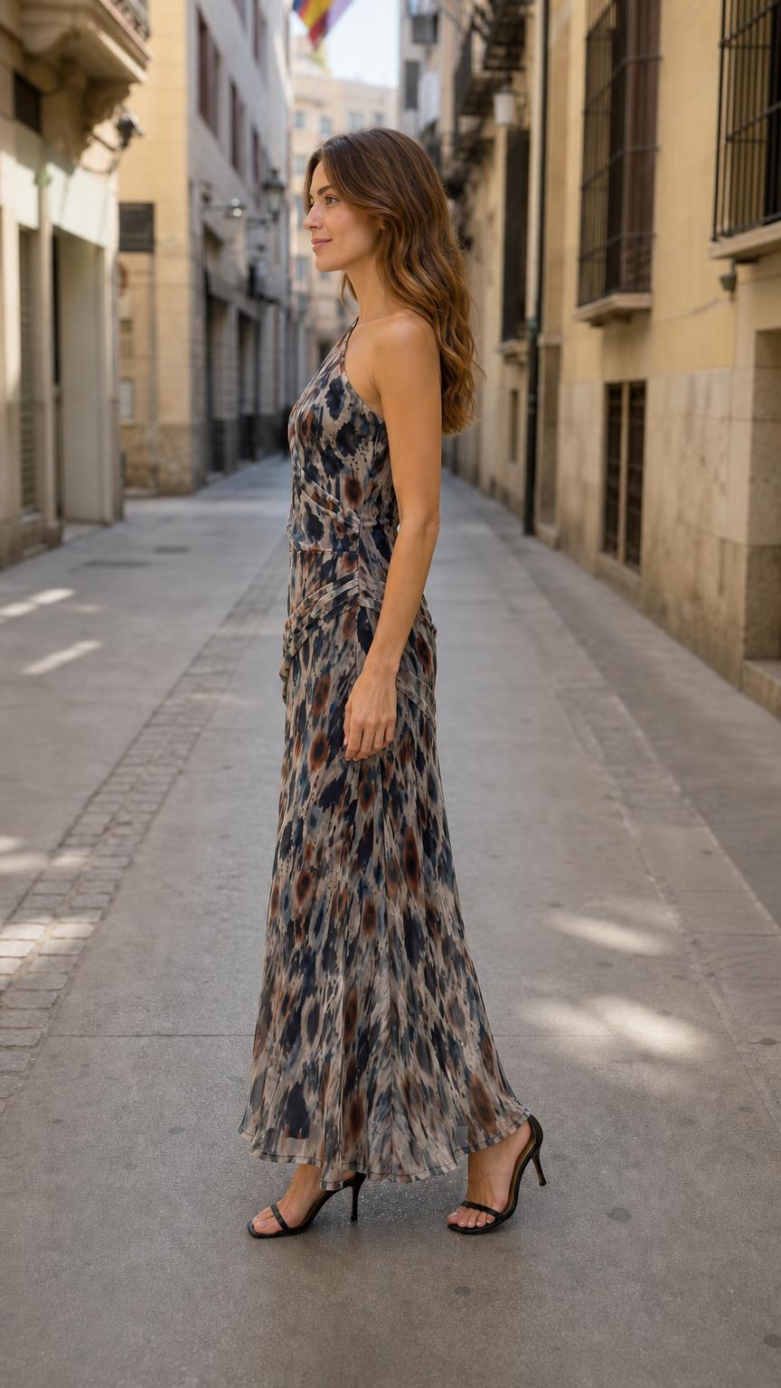 Side profile view of model wearing one-shoulder maxi dress