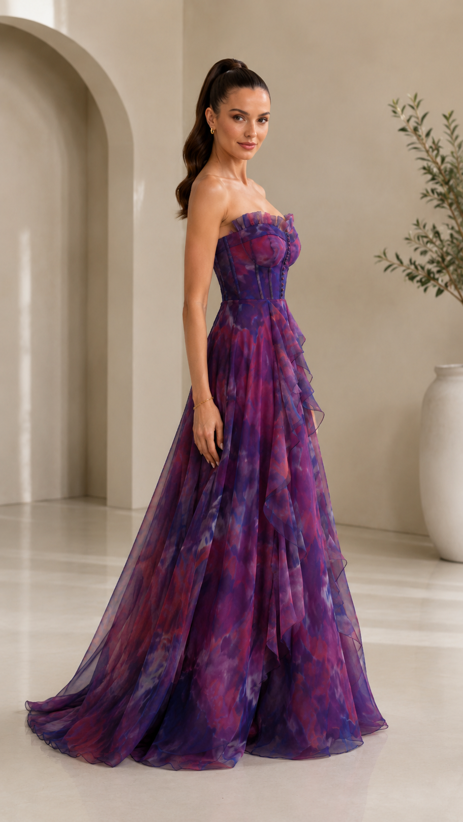 Side view of purple printed strapless floor-length formal gown with sheer layered skirt
