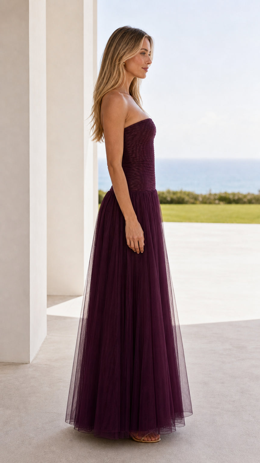Side view of burgundy strapless ruched tulle maxi dress